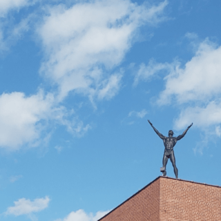 The Native American Indian stands on the roof of the Alan Cottrill Gallery.
