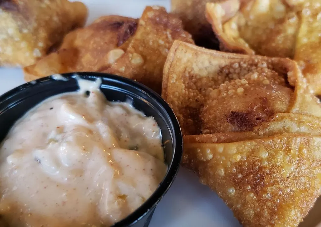 Fried egg rolls are shown on a plate with dipping sauce for Columbus Ohio's Restaurant Week. 